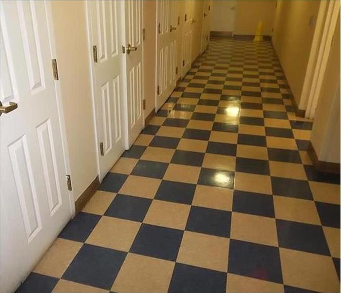 The same blue and white checkered floor that looks new and shiny with the lights bouncing right off of it.