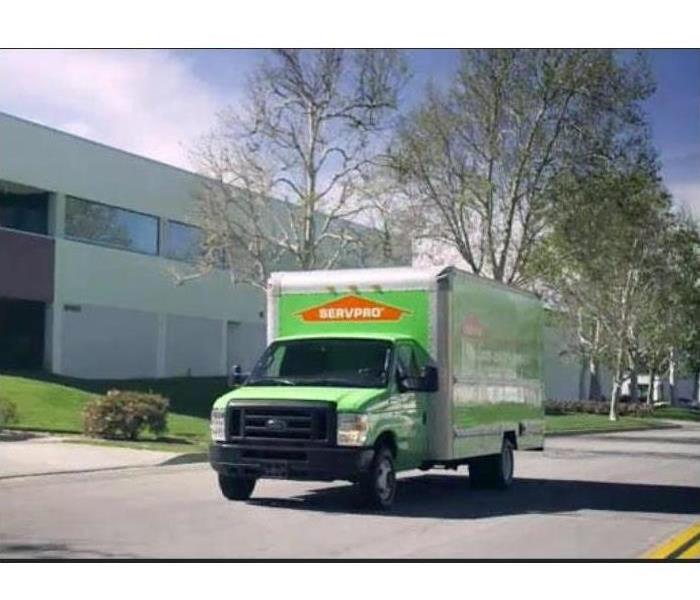 A SERVPRO truck is parked in front of an office building