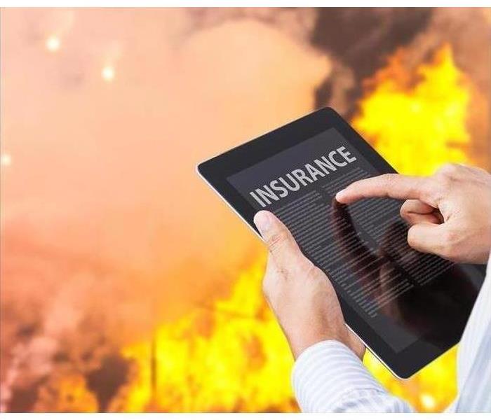 A tablet is used to document information at the site of a fire