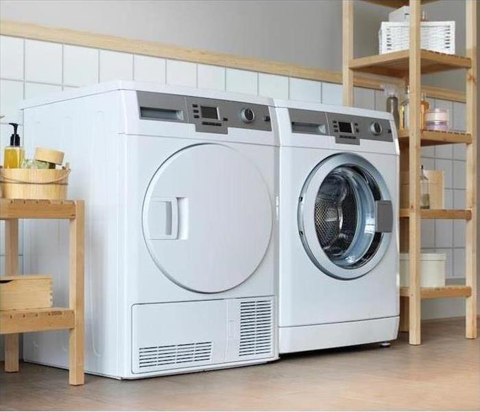 A washer and dryer sit side by side in a laundry room