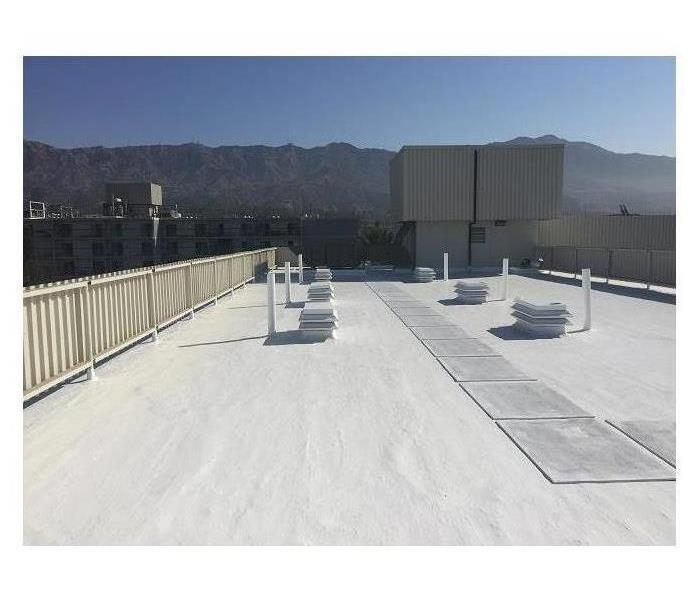 Snow lies on the roof of a large commercial facility